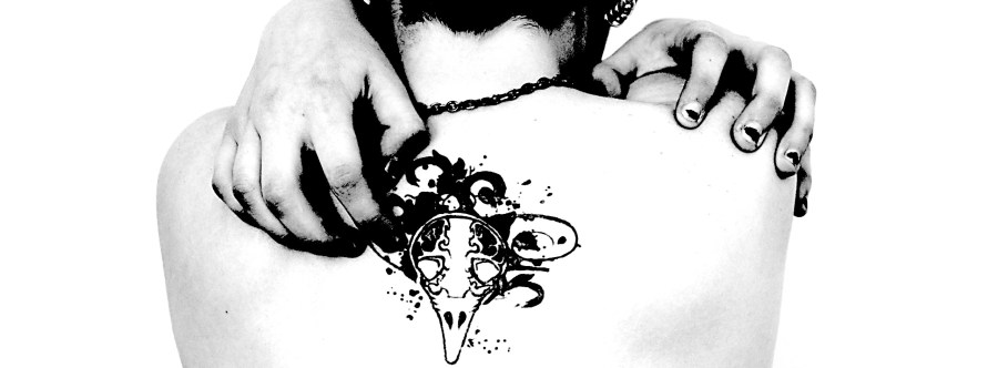 Black and white portrait photograph of a tattooed woman